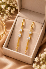 Pair of gold crystal drop earrings in jewelry box